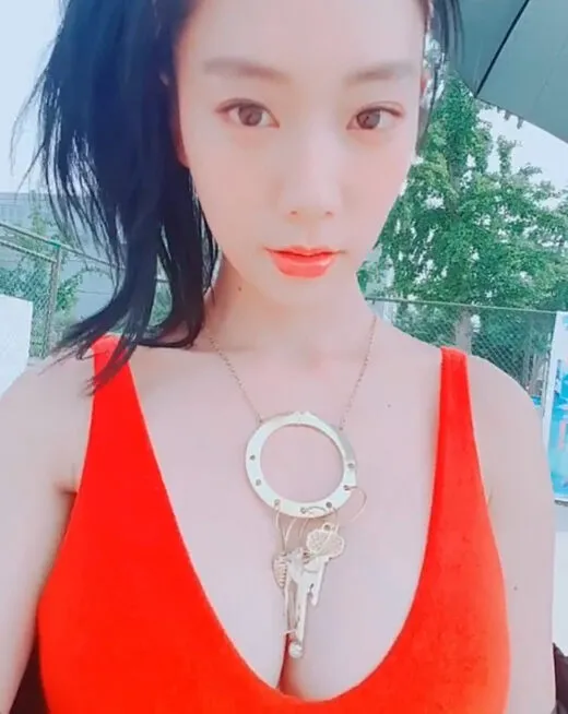 Clara stuns in bright red swimsuit, showcasing overwhelming proportions that look like a professional photoshoot